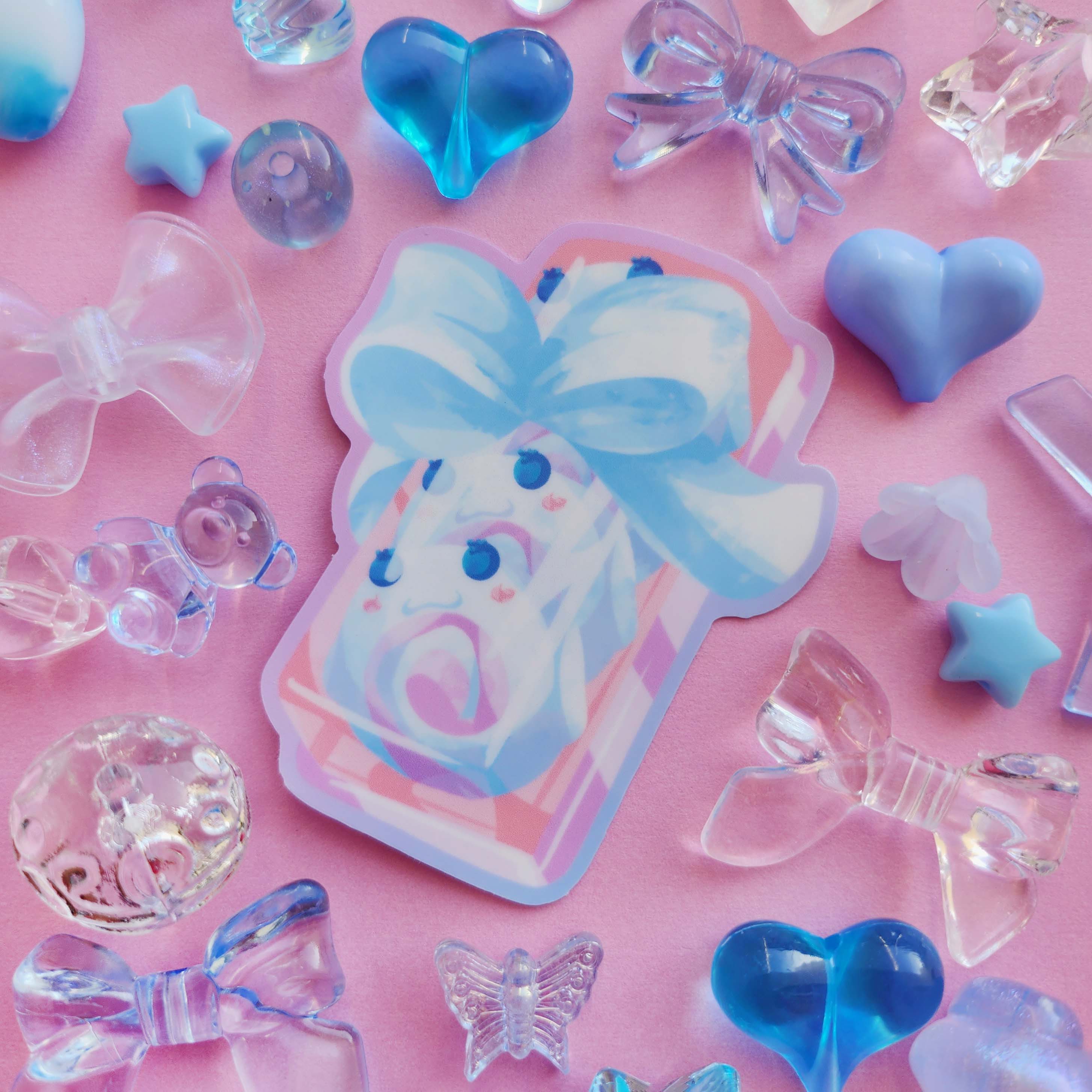 Sticker design in the centre of the image. Decorative craft beads surround the sticker