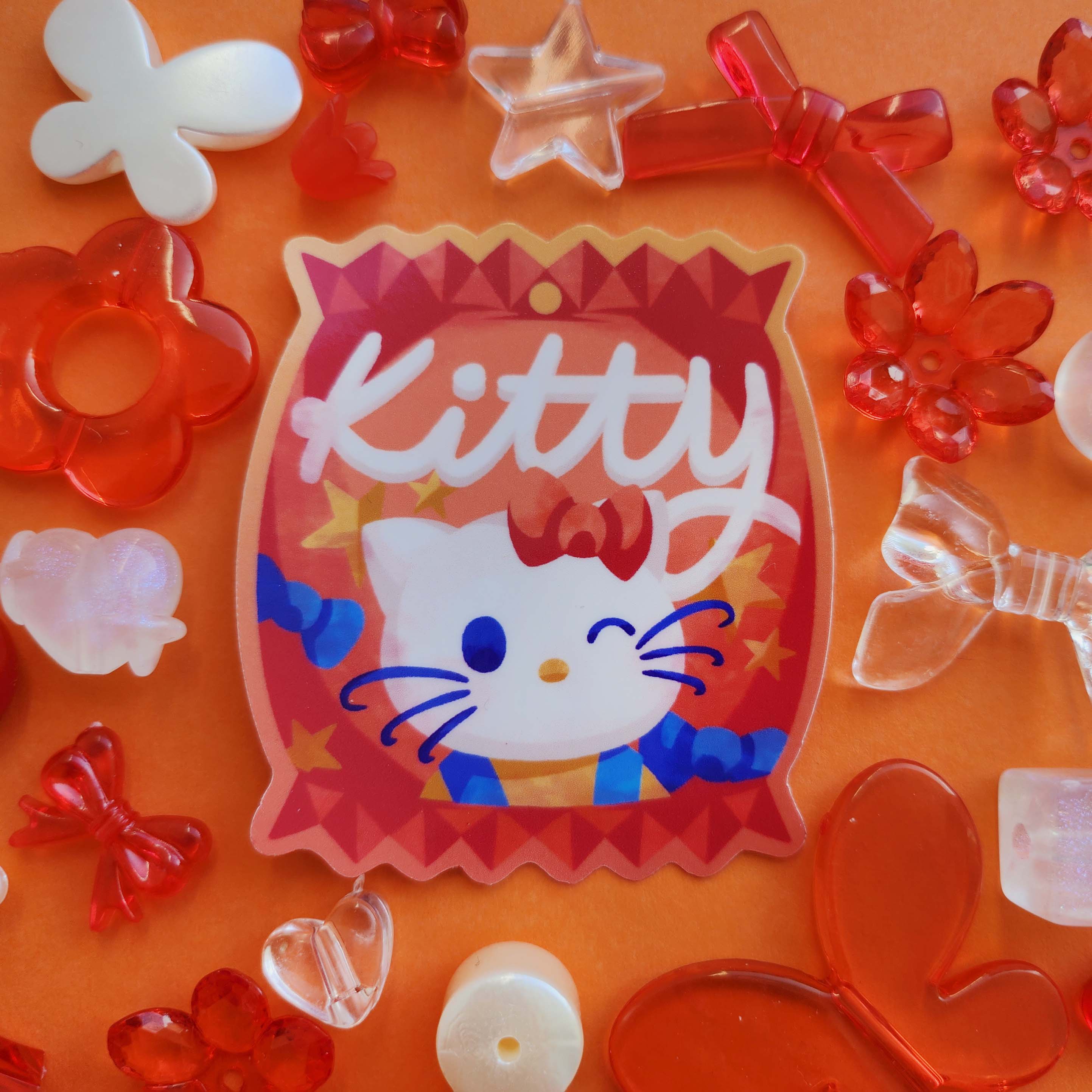 Sticker design in the centre of the image. Decorative craft beads surround the sticker