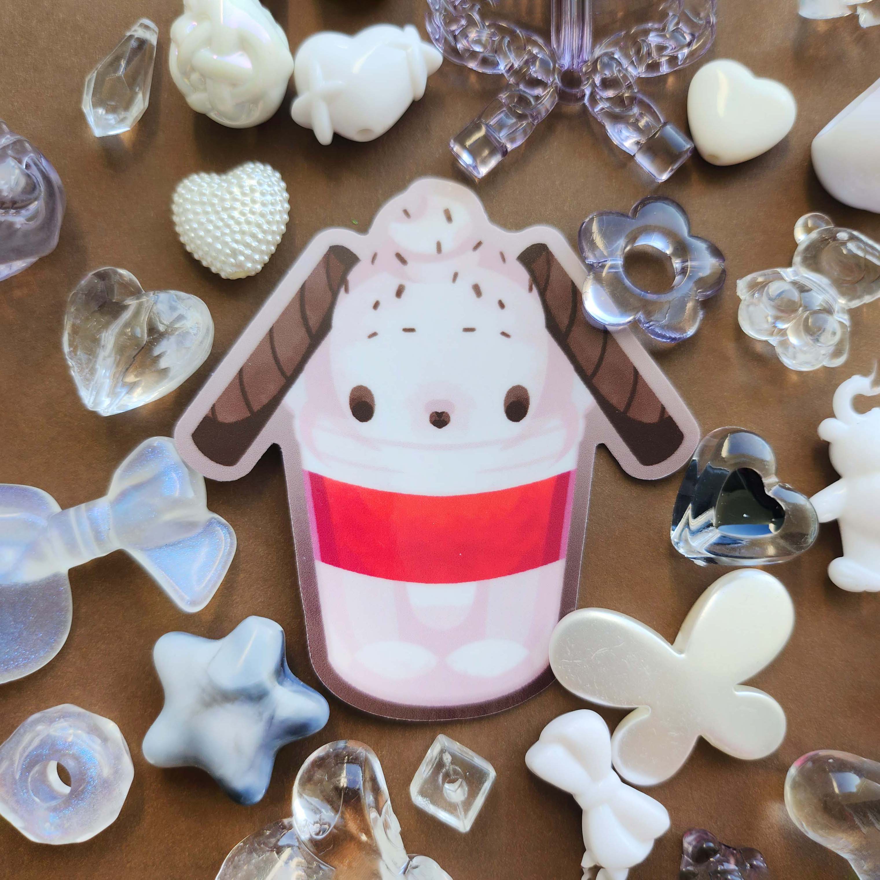 Sticker design in the centre of the image. Decorative craft beads surround the sticker